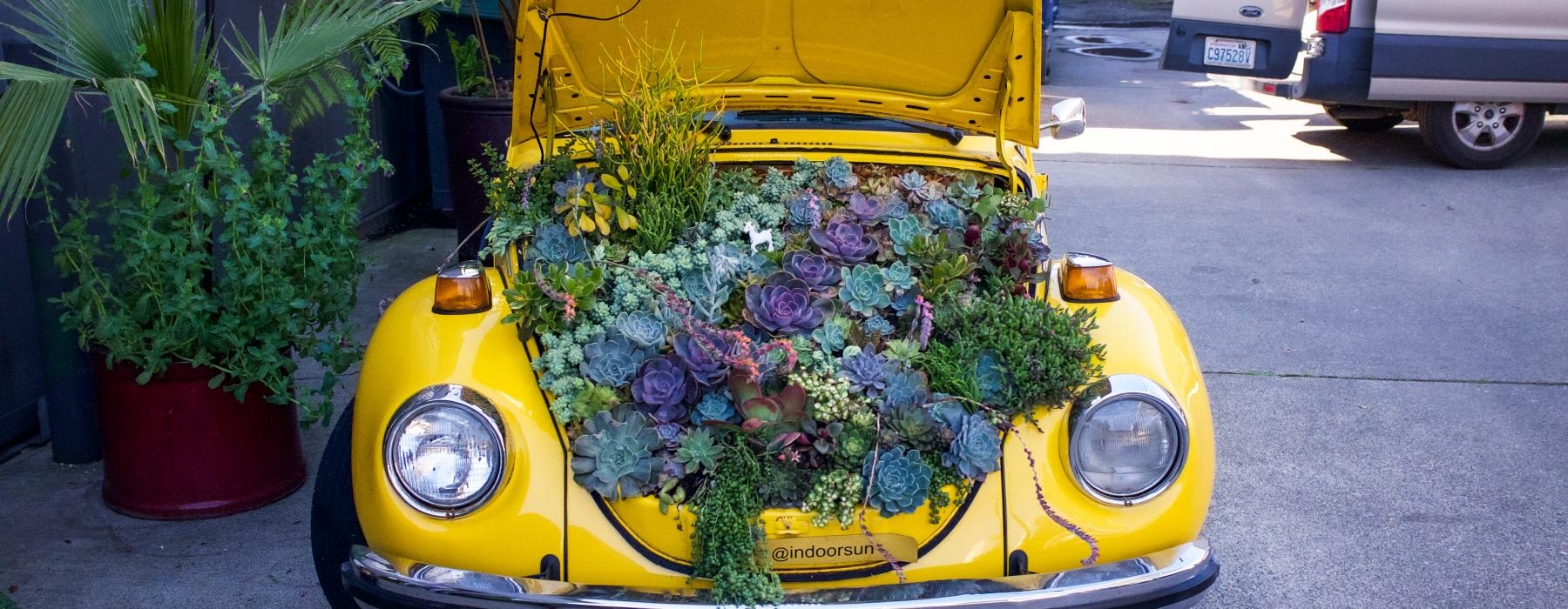 a yellow car with flowers in it